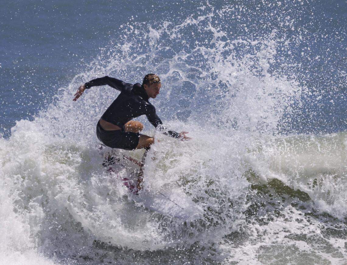 Jason Paruta catches a wave during the morning on Thursday, Aug. 21, 2025, off the beach in Stuart, Fla. Surfers estimated that waves ranged from 8 - 12 feet all morning.