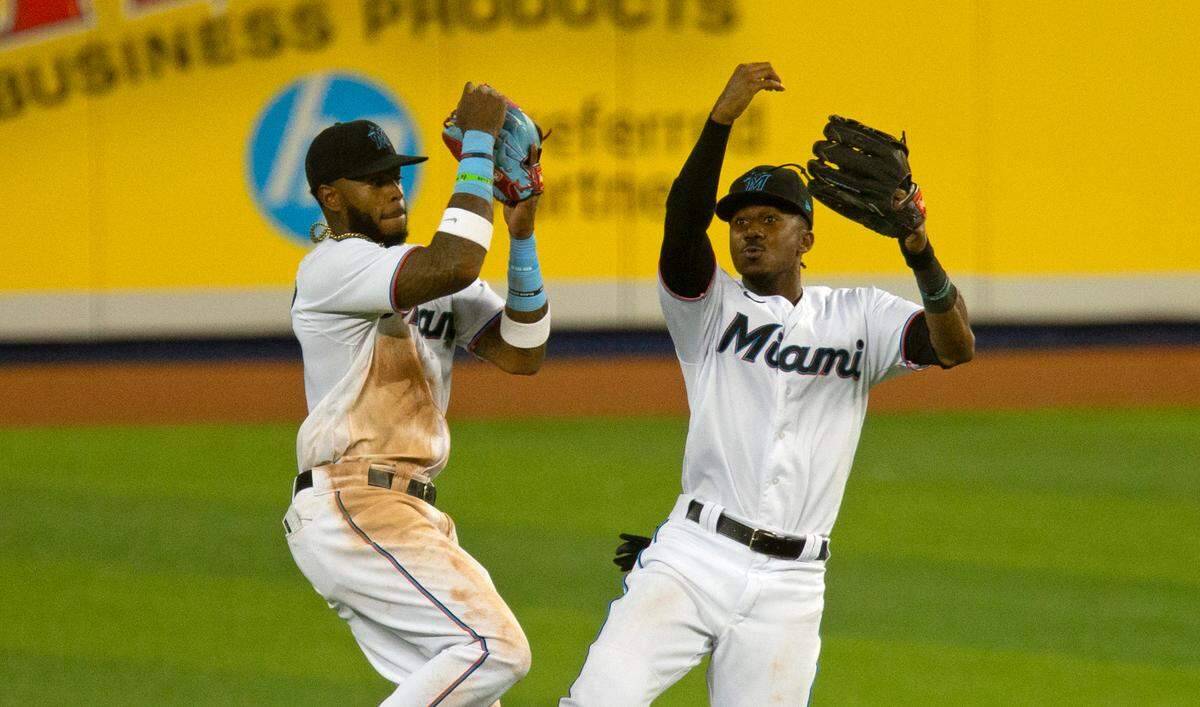 Miami Marlins outfielders Monte Harrison (4) and Lewis Brinson (25) celebrate their 8-4 win over the Boston Red Sox during a baseball game at at Marlins Park in Miami on Wednesday, September 16, 2020.