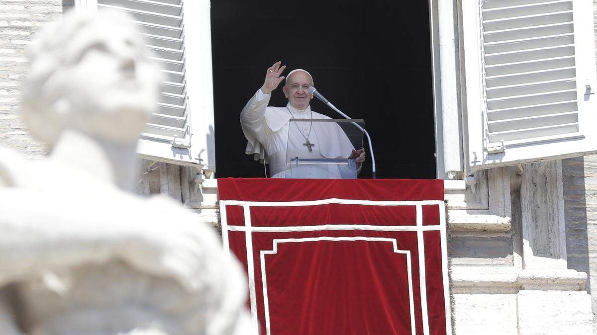 Pope Francis waves to faithful from his studio’s window overlooking St. Peter’s Square during the Angelus noon prayer at the Vatican, Sunday, Aug. 18, 2019.