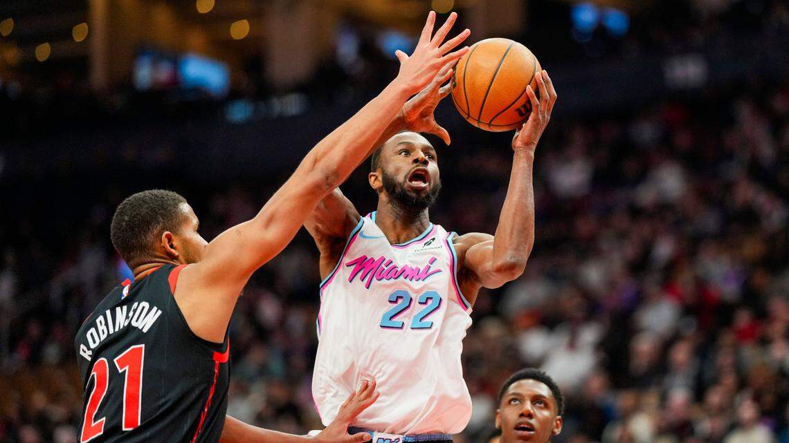 Miami Heat forward Andrew Wiggins (22) drives to the basket against Toronto Raptors center Orlando Robinson (21) during the first half at Scotiabank Arena.