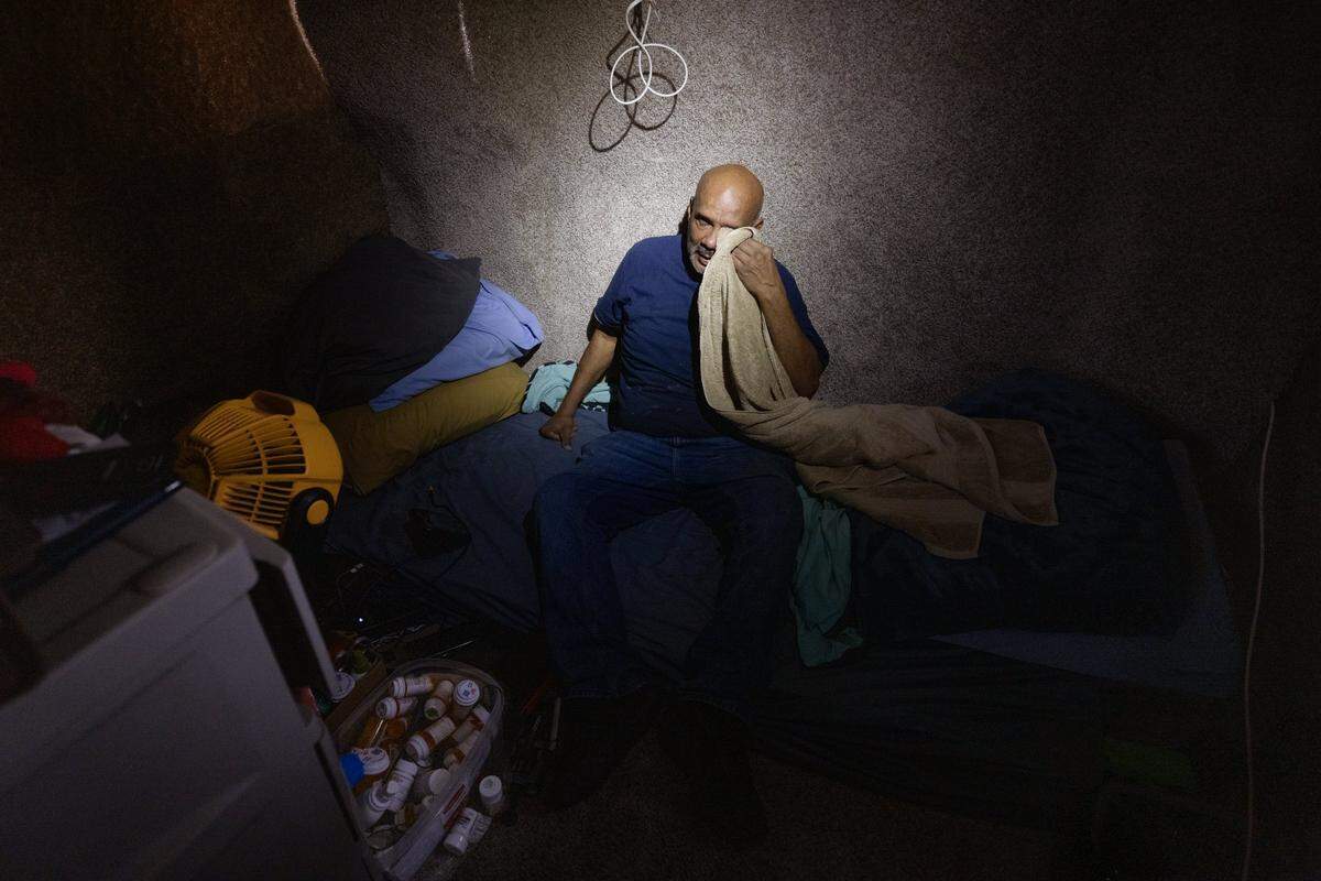 Angel Rogelio Diaz Franco sits inside the van in which he now lives on Sunday, Dec. 21, 2025, in Miami.