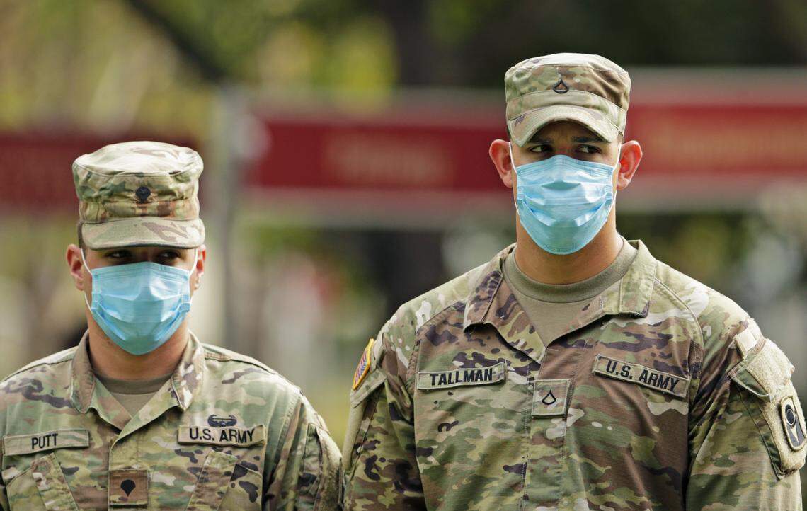 Florida Army National Guard soldiers wearing protective masks during Florida Gov. Ron DeSantis press conference at the Urban League of Broward County to announces Florida’s first two walk-through coronavirus testing sites will be opening in Broward County as the Novel Coronavirus pandemic continues on Friday, April 17, 2020 in Fort Lauderdale. The sites will open for testing on Saturday and will start with 200 tests per day, Florida Gov. DeSantis said