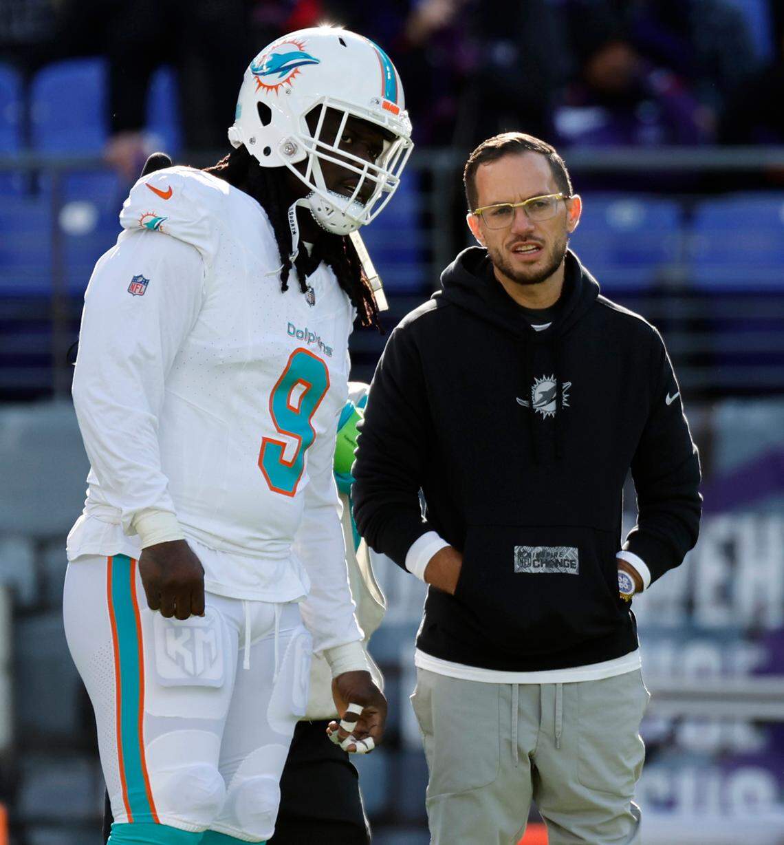 Miami Dolphins coach Mike McDaniel talks his Dolphins linebacker Melvin Ingram (9) during warmups before the start of an NFL football game against the Baltimore Ravens at M&T Bank Stadium in Baltimore, Maryland on Sunday, December 31, 2023.