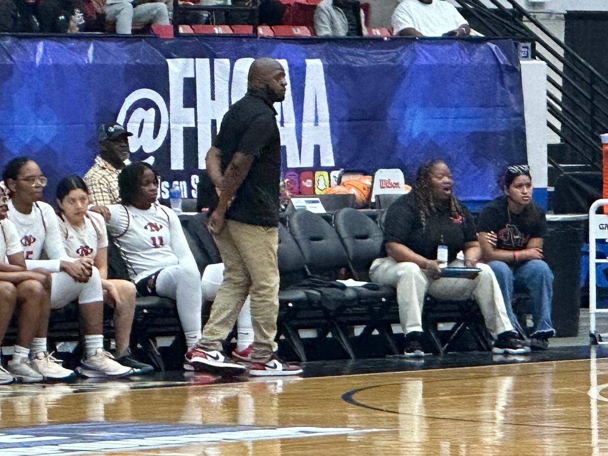 Northeast girls’ basketball coach Lawrence Hanna looks on while his team plays in a Class 5A state semifinal on Wednesday at the RP Funding Center in Lakeland, Fla.