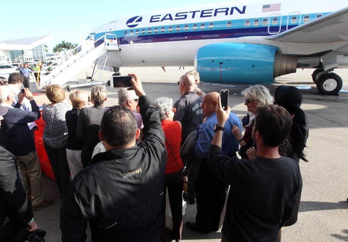 Visitors and friend take pictures as the new Eastern Airlines charter service welcomes its first aircraft to Miami International Airport in December 2014. 