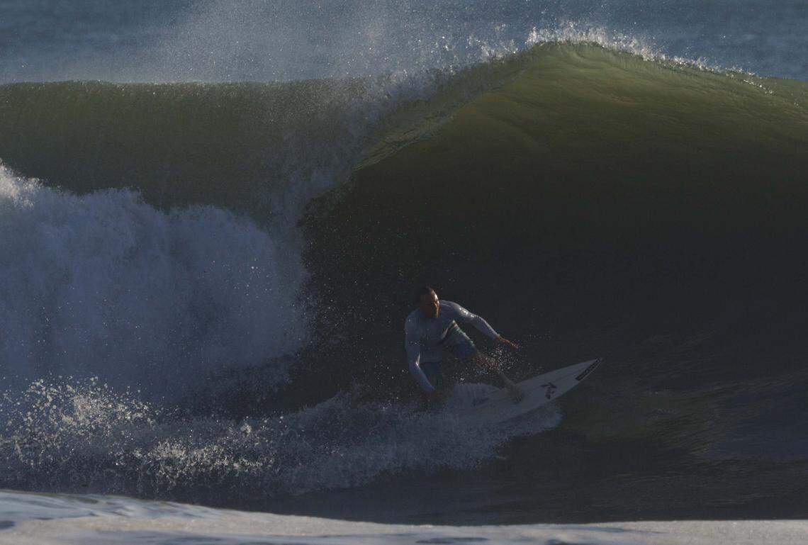 A local surfer catches a wave during the morning on Thursday, Aug. 21, 2025, off the beach in Stuart, Fla. Surfers estimated that waves ranged from 8 - 12 feet all morning.
