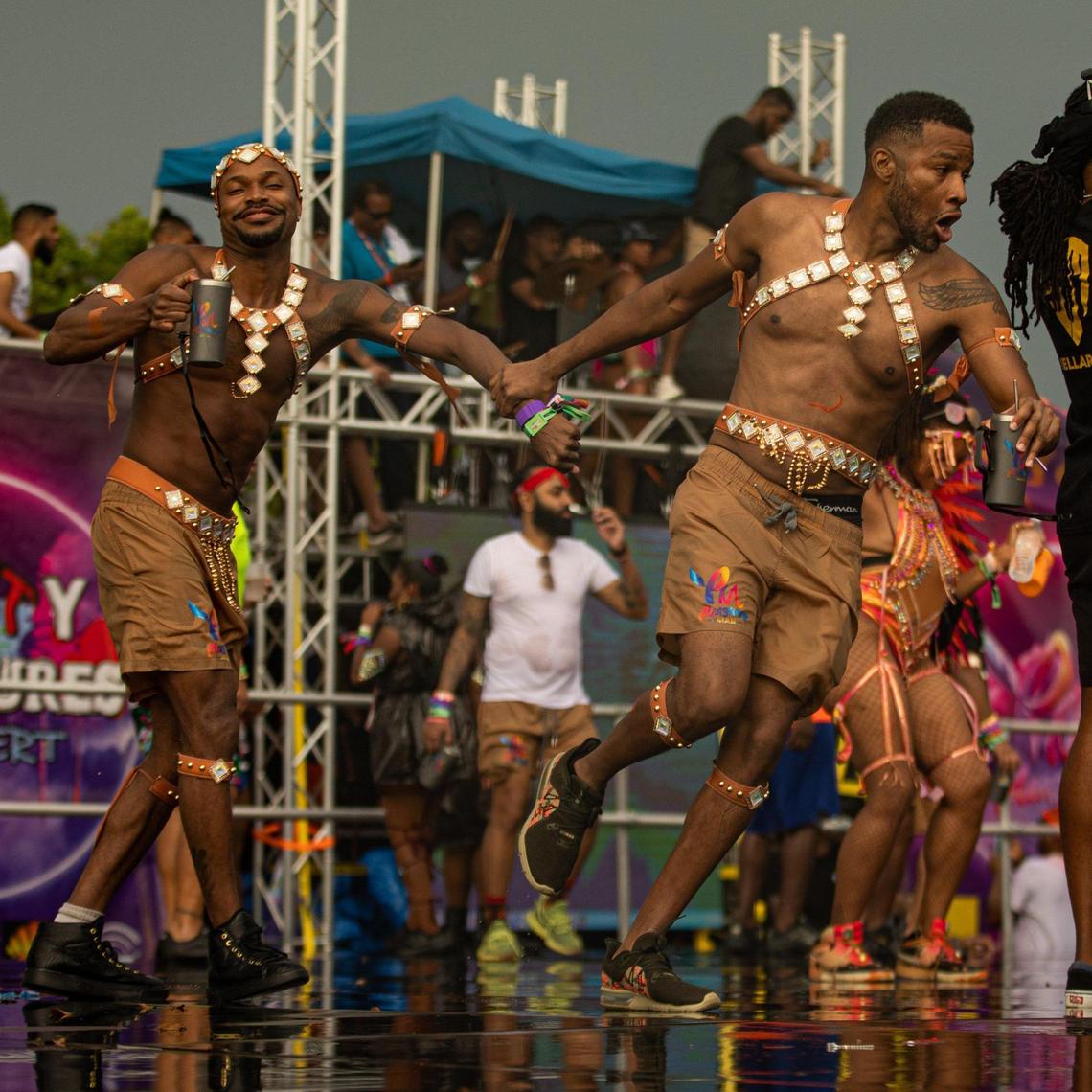Performers run across the stage during Miami Carnival at the Miami-Dade County Fair Expo in Miami, Florida on Sunday, October 9, 2022.