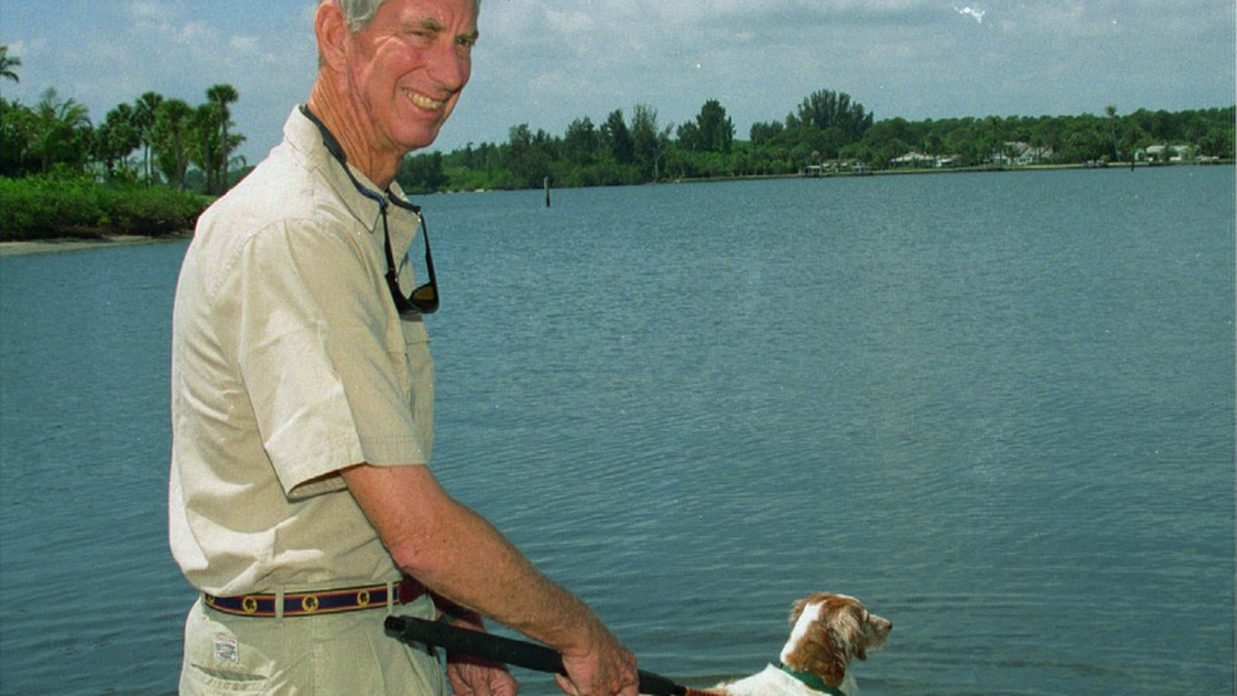 Nat Reed, a prominent environmentalist, cast a line in the Indian River, accompanied by his family dog, Hobe, in this photo taken April 24, 1996. Reed, 84, died Wednesday.