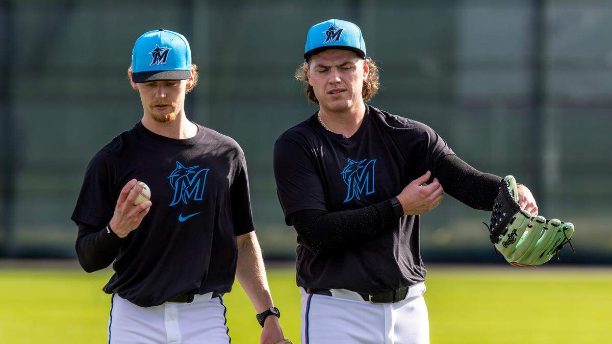 Miami Marlins pitcher Max Meyer (23) talks with teammate pitcher Ryan Weathers during spring training workouts for pitchers and catchers at Roger Dean Stadium in Jupiter, FL, on Wednesday, Feb. 12, 2025.