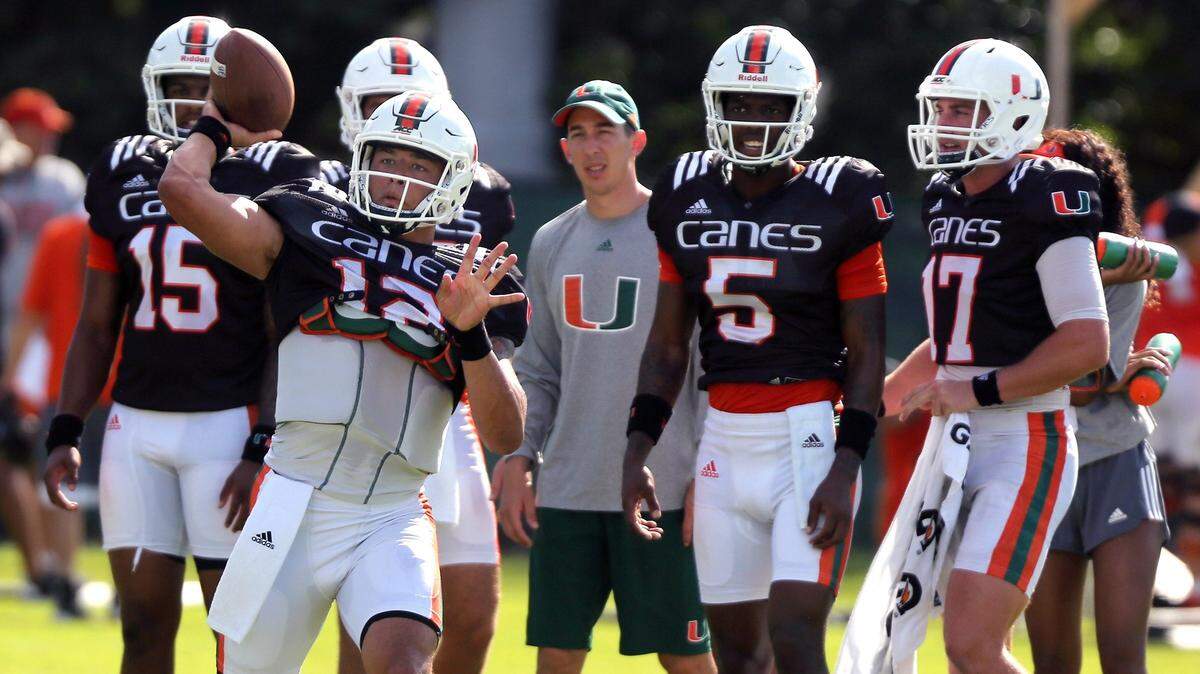 University of Miami quarterback Malik Rosier (12), along with the other UM quarterbacks, is shown here recently during practice at Greentree Field on campus. Pictured at right are backups N’Kosi Perry (5) and Cade Weldon (17). Freshman Jarren Williams is at far left.