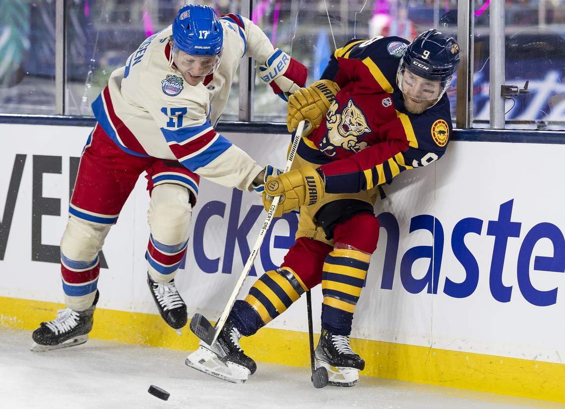 Florida Panthers center Sam Bennett (9) passes the puck as New York Rangers defenseman Will Borgen (17) defends in the first period of their Winter Classic outdoor hockey game at loanDepot park on Friday, Jan. 2, 2026, in Miami, Fla.