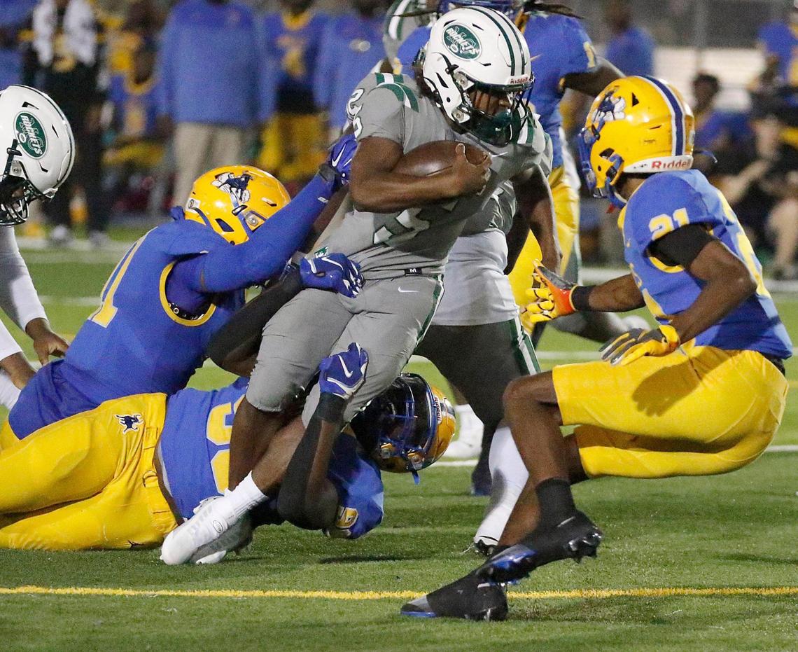Miami Central Rockets running back Ean Pope (5) carries the ball against Northwestern Bulls during football game on Friday, October 7, 2022 at Traz Powell Stadium in Miami. Andrew Uloza / for Miami Herald