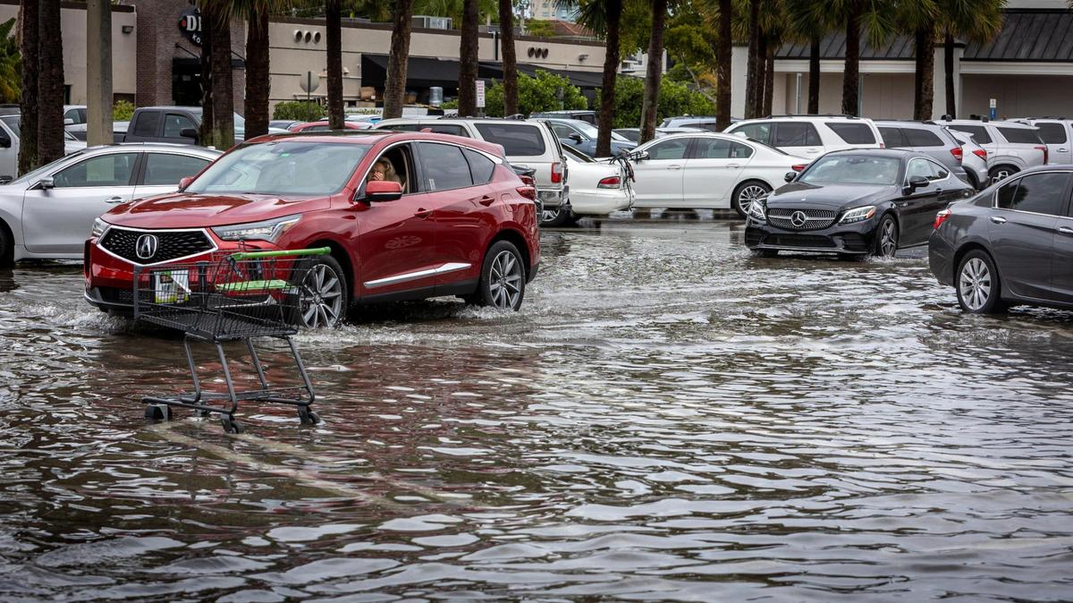 Vehicles move through a flooded parking lot at Town Center in Aventura on April 24, 2023. Heavy rainstorms and flooding are expected in the Miami and Fort Lauderdale area Monday and Tuesday.