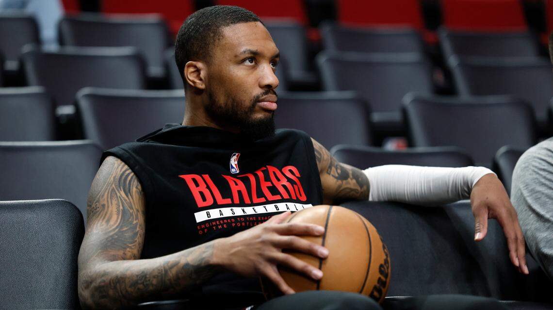 Portland Trail Blazers point guard Damian Lillard (0) watches players warm up prior to the game against the New Orleans Pelicans at Moda Center.