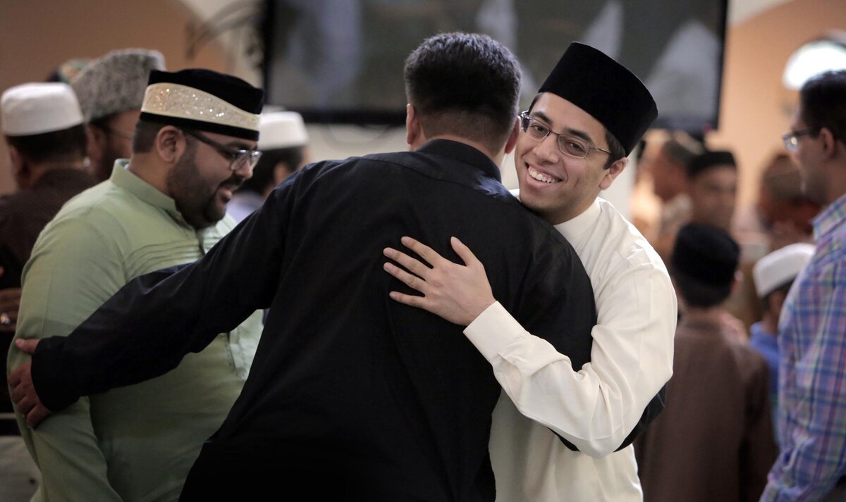 Members of the Baitul Naseer Mosque greet each other after the service.