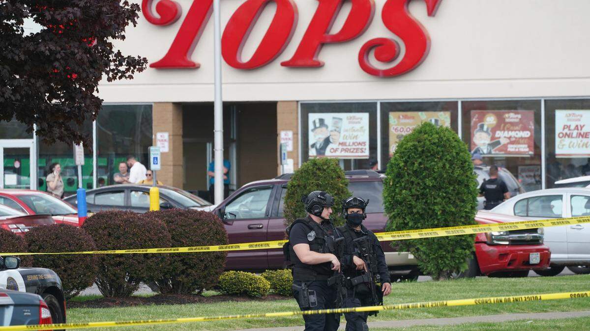 Police secure an area around a supermarket where several people were killed in a shooting, Saturday, May 14, 2022, in Buffalo, New York.
