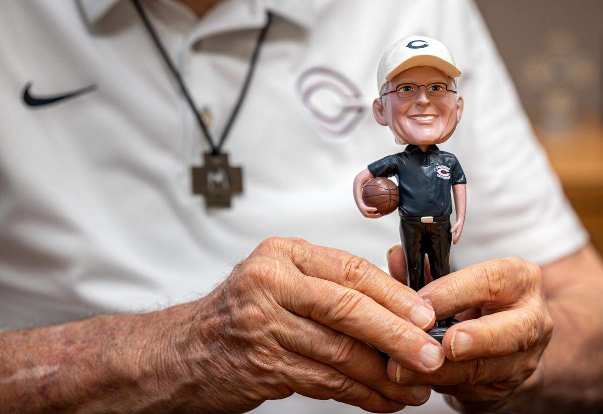 Brother Kevin Handibode holds bobblehead of himself at Christopher Columbus High School on Friday, May 22, 2026 in Miami, Fla.