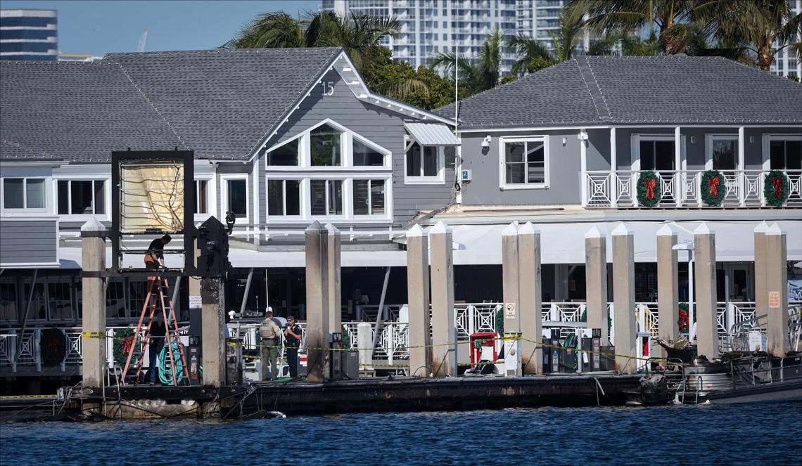 A small charred small boat remains on the scene as FWC investigates the explosion that left one person and five others injured continues at the Lauderdale Marina on Tuesday, December 24, 2024 after 911 callers reported that a boat was engulfed in flames in Fort Lauderdale, Florida.