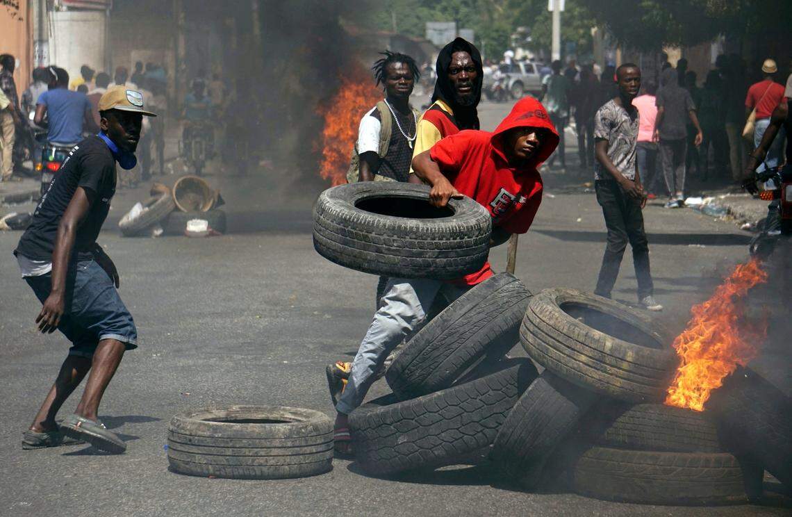 Anti-government protesters set up a barricade of burning tires as they demand the resignation of President Jovenel Moise in Port-au-Prince on June 13, 2019.