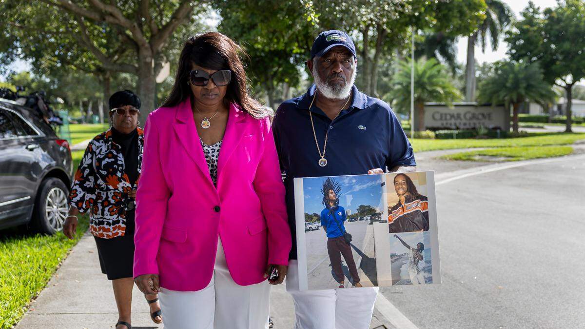 Marcia Dixon and Edward Dixon, the parents of Edwin Dixon, who was killed in a shooting at Cedar Grove Apartments, leave after attending a press conference outside the neighborhood on Wednesday, Oct. 23, 2024, in Miami Gardens, Fla. The event announced a lawsuit filed against the apartment’s property management following three shootings at the complex that left two dead and one injured.