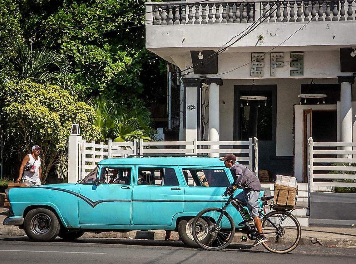 A car passes in front of the EFE bar in Havana on July 29, 2025. The bar, owned by Cuban influencer Sandro Castro, grandson of the late Fidel Castro, has gained notoriety as the backdrop for several of Sandro's viral videos shared on social media.   