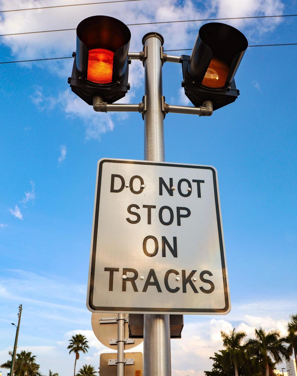 Warning signs are displayed at U.S. 1 intersections along the Brightline train corridor in Miami on Jan. 7, 2022.
