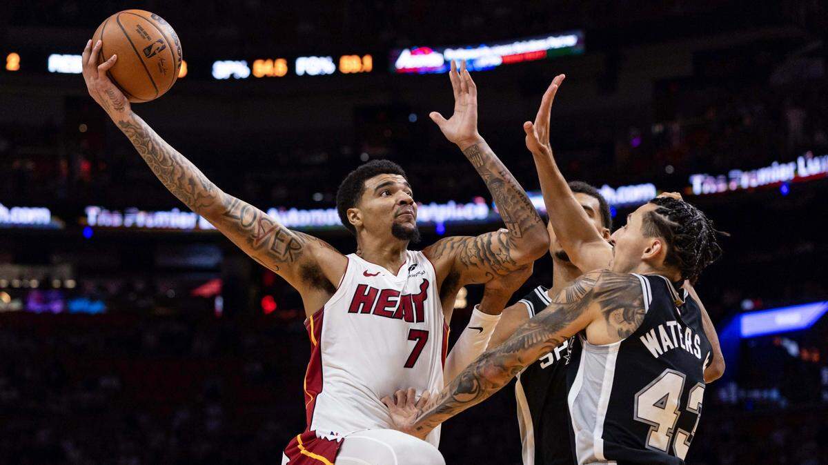 Miami Heat center Kel'El Ware (7) attempts a shot over San Antonio Spurs center Victor Wembanyama (1) and forward Lindy Waters III (43) during the first half of an NBA preseason game at Kaseya Center on Wednesday, October  8, 2025, in Miami, Fla.
