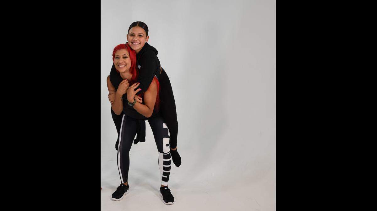 Dance director Mady Richmond and student Ayleen De Anda share a moment. Richmond directs Mady’s Dance Factory in Miami and founded the nonprofit One Heart Foundation to help children overcome obstacles in their lives through dance.