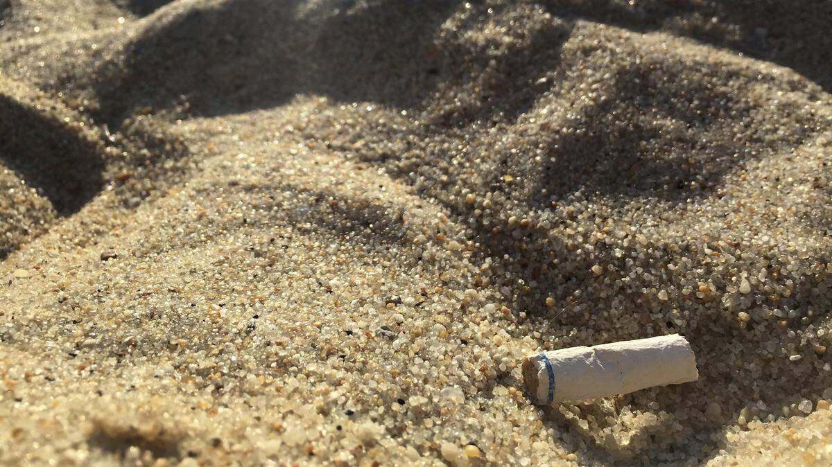 In this Aug. 25, 2018, photo a cigarette butt lies on the sand at a beach in Middletown, New Jersey. A ban on smoking tobacco at public beaches in Florida has been proposed by Florida Sen. Joe Gruters on Jan. 2, 2019. If passed, the law would go into effect July 1.