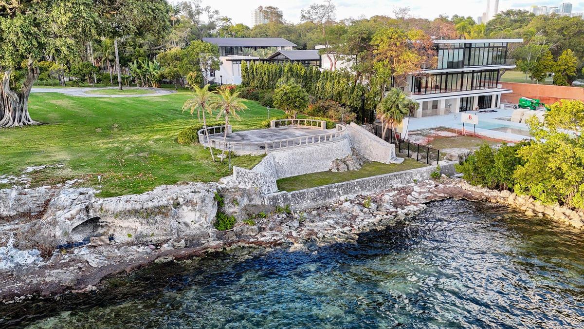 A drone view shows portions of Silver Bluff, a protected 120,000-year-old limestone ridge that runs along the Coconut Grove shoreline, behind estate homes on Brickell Avenue. During construction of the mansion at right, a contractor sliced the top off a 46-foot-long piece of the bluff between the swimming pool and the architectural landscape viewing feature on the adjoining property.