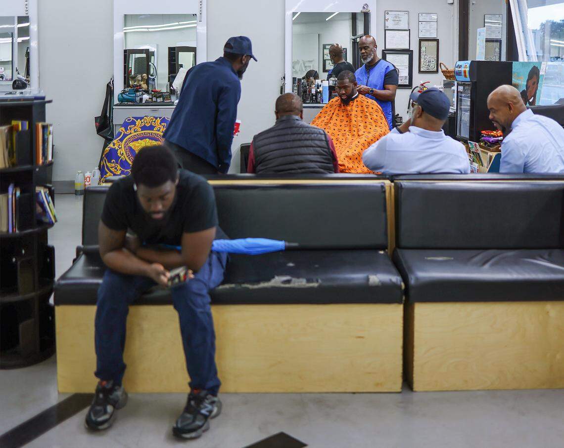 Topcuttaz Barbershop owner Mike Stephens, 58, cuts the hair of Jefferson Noel, 31, at a gathering of Black men who come together to discuss issues relevant to the Black community. This time they were discussing life under the second Trump administration. 