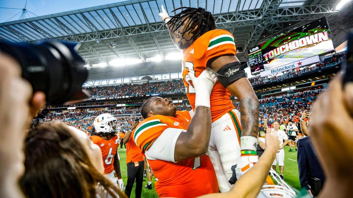 Miami Hurricanes running back Mark Fletcher Jr. (22) celebrates on the field with teammates after scoring in overtime to defeat Virginia Cavaliers at Hard Rock Stadium in Miami Gardens on Saturday, October 28, 2023.