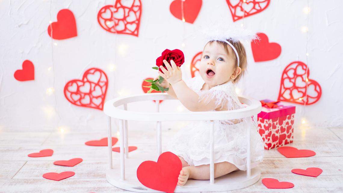 baby girl playing with rose
