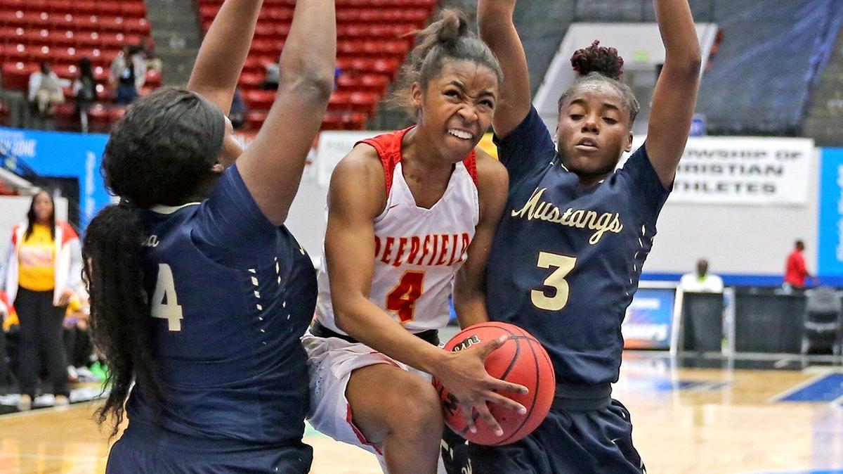 Deerfield Beach HS Jasmin Worsley (10) leaps between Wekiva HS defenders Jacqulyn Butler (34) and Myanna Garrett (3) in the 9A Semi-Finals Girl’s State Basketball Championships at the RP Funding Center in Lakeland, Florida, Friday, March, 1, 2019.