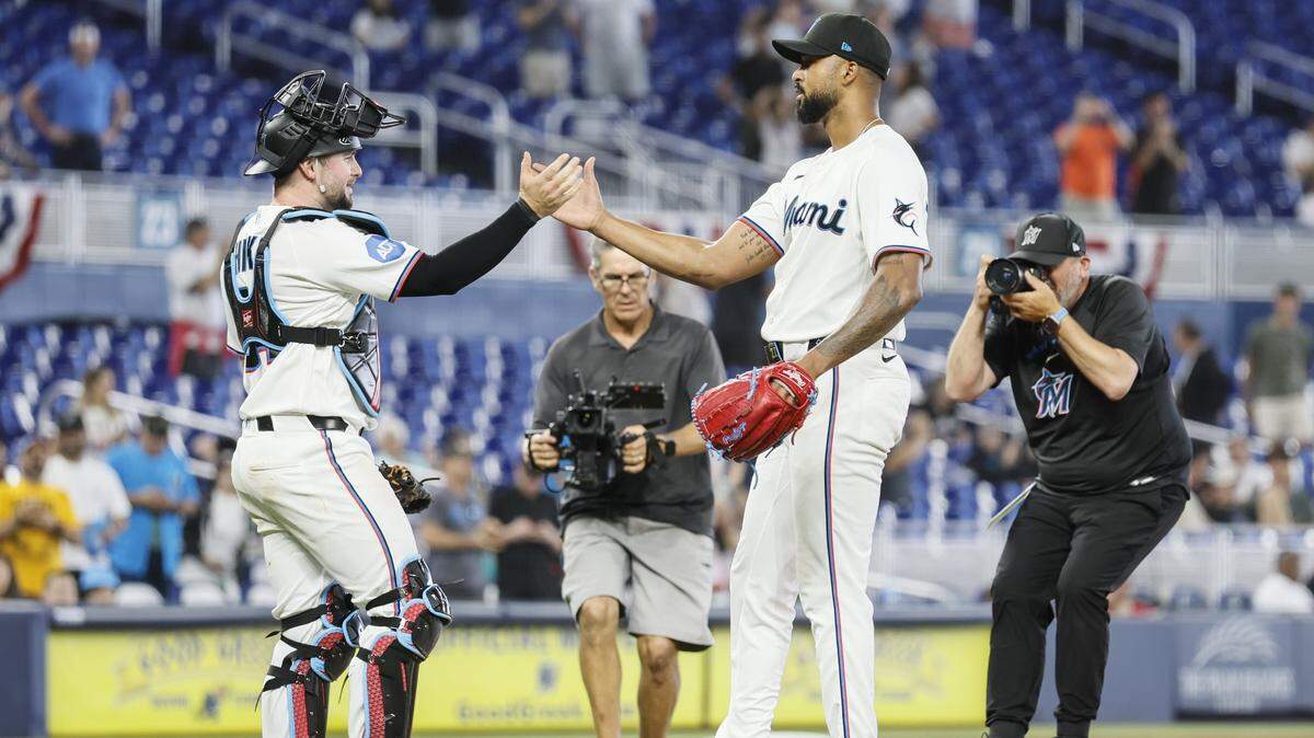 Miami Marlins catcher Liam Hicks (34) celebrates with pitcher Sandy Alcantara (22) after Alcantara finishes a complete game shutout against the Chicago White Sox at loanDepot Park in Miami, Florida, on Wednesday, April 1, 2026. 