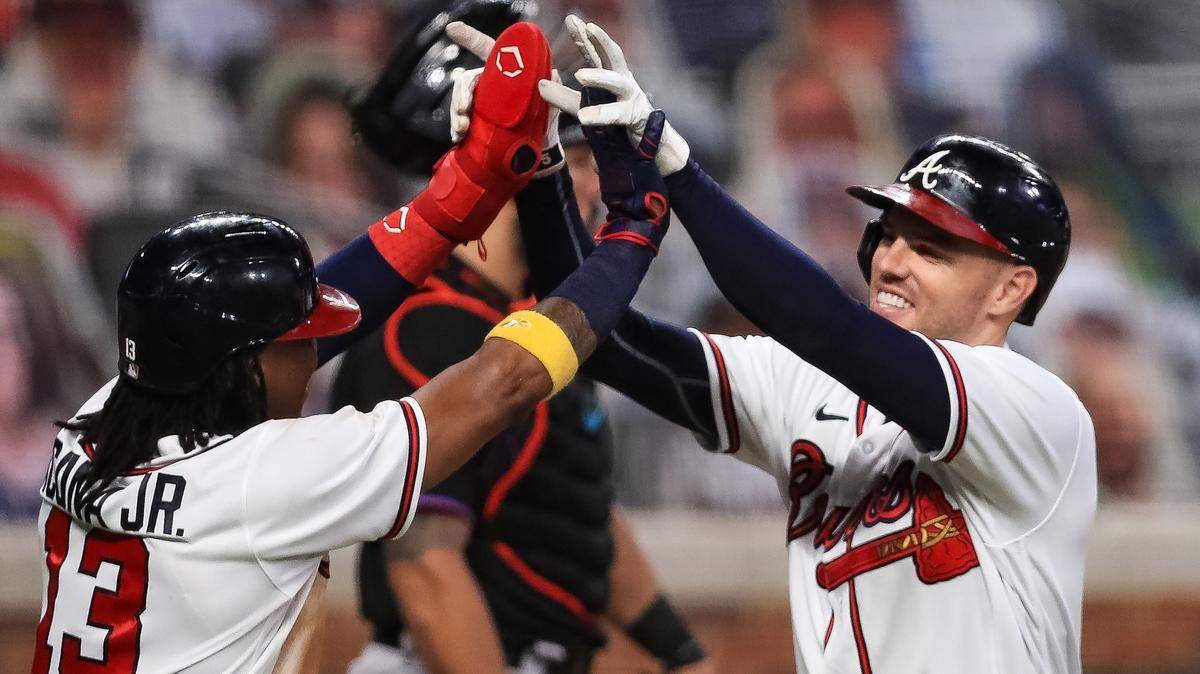ATLANTA, GEORGIA - SEPTEMBER 09: Freddie Freeman #5 of the Atlanta Braves celebrates with Ronald Acuna Jr. #13 after hitting a home run during the third inning of a game against the Miami Marlins at Truist Park on September 9, 2020 in Atlanta, Georgia. (Photo by Carmen Mandato/Getty Images)