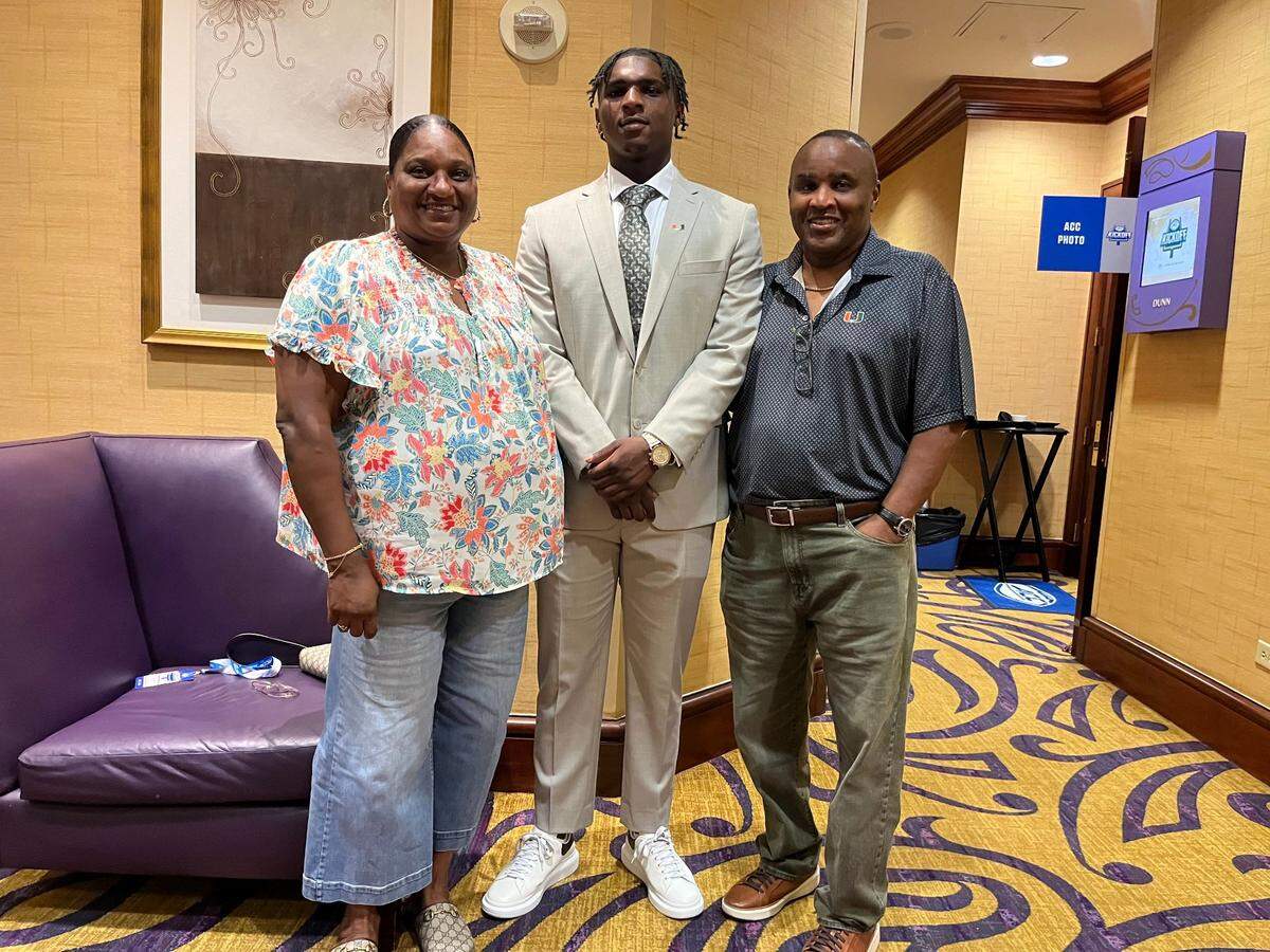 Miami Hurricanes quarterback Cam Ward (center) with parents Patrice Ward (left) and Calvin Ward (right) at the 2024 ACC Football Kickoff in Charlotte, North Carolina.