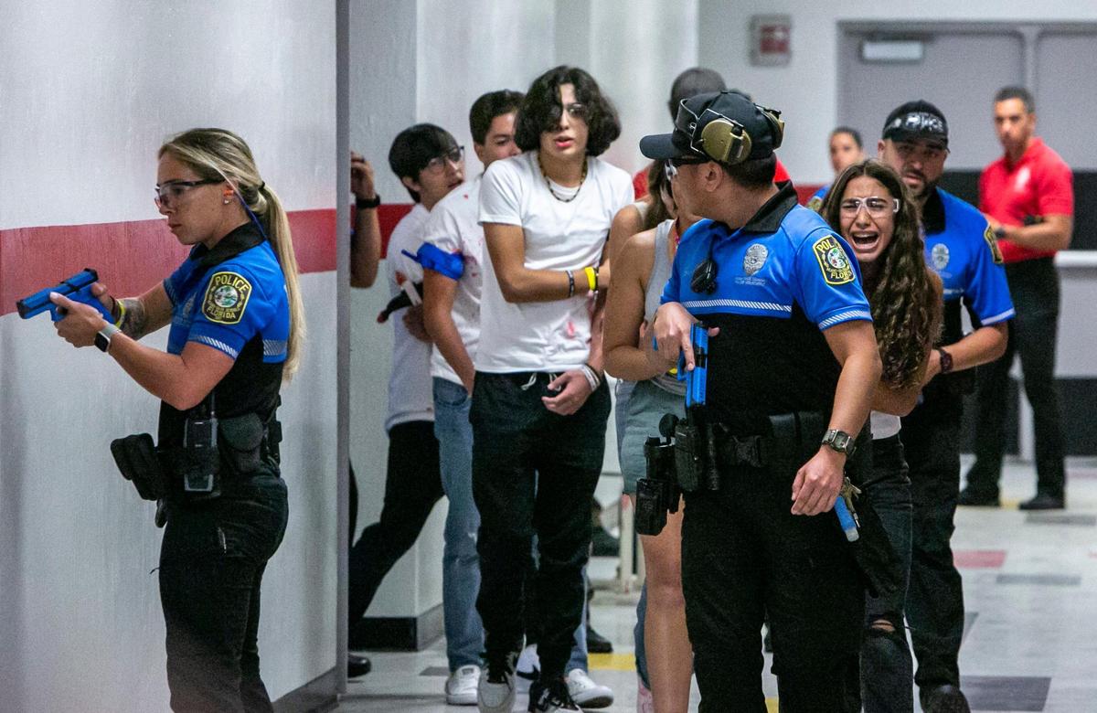 Injured victims are escorted out of a classroom by Miami-Dade Schools Police during an active shooter drill held at Coral Gables Senior High School on Friday, July 15, 2022.