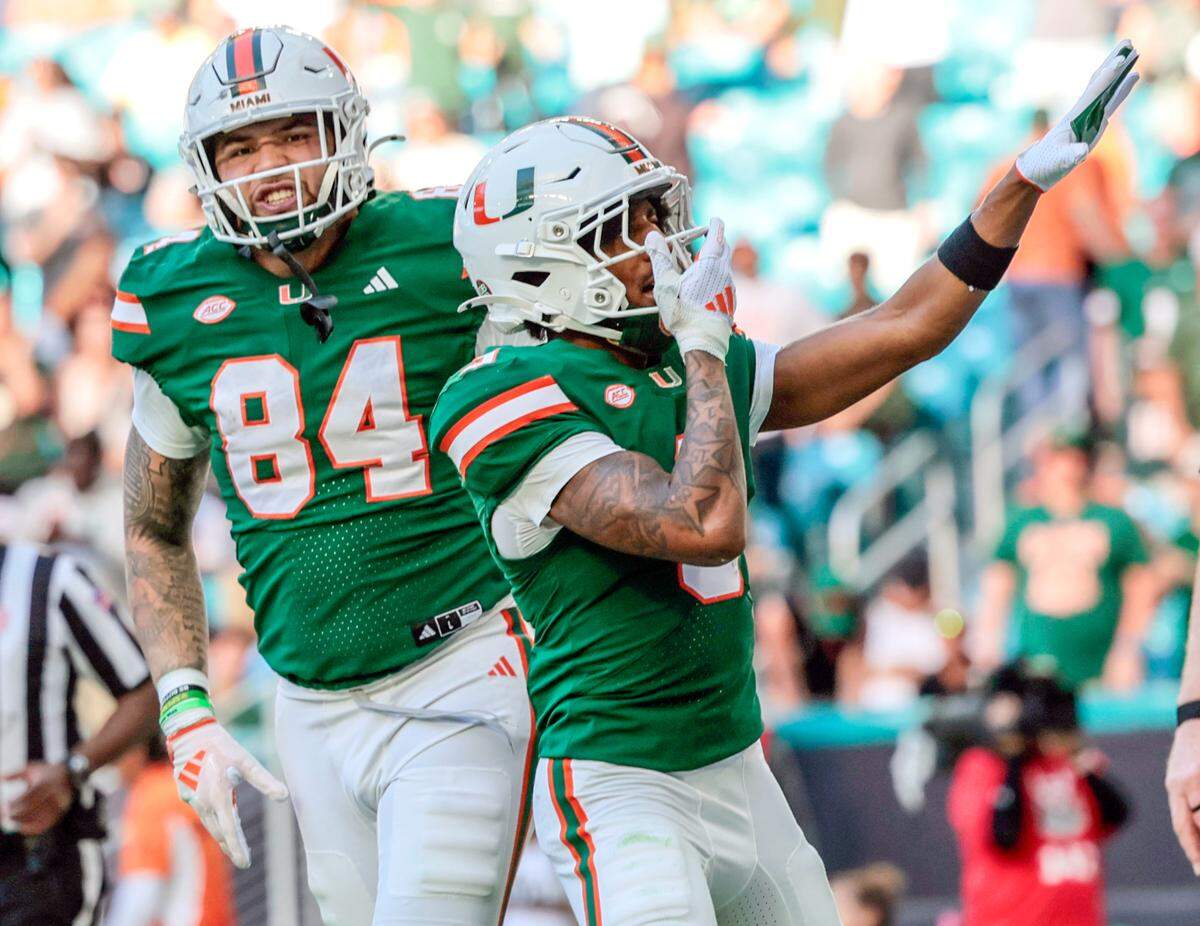 Miami Hurricanes wide receiver Jacolby George (3) and tight end Cam McCormick (84) celebrate George’s score against the Wake Forest Demon Deacons on his way to score in the second half of their NCAA game in Miami Gardens, Florida, on Saturday, November 23, 2024.