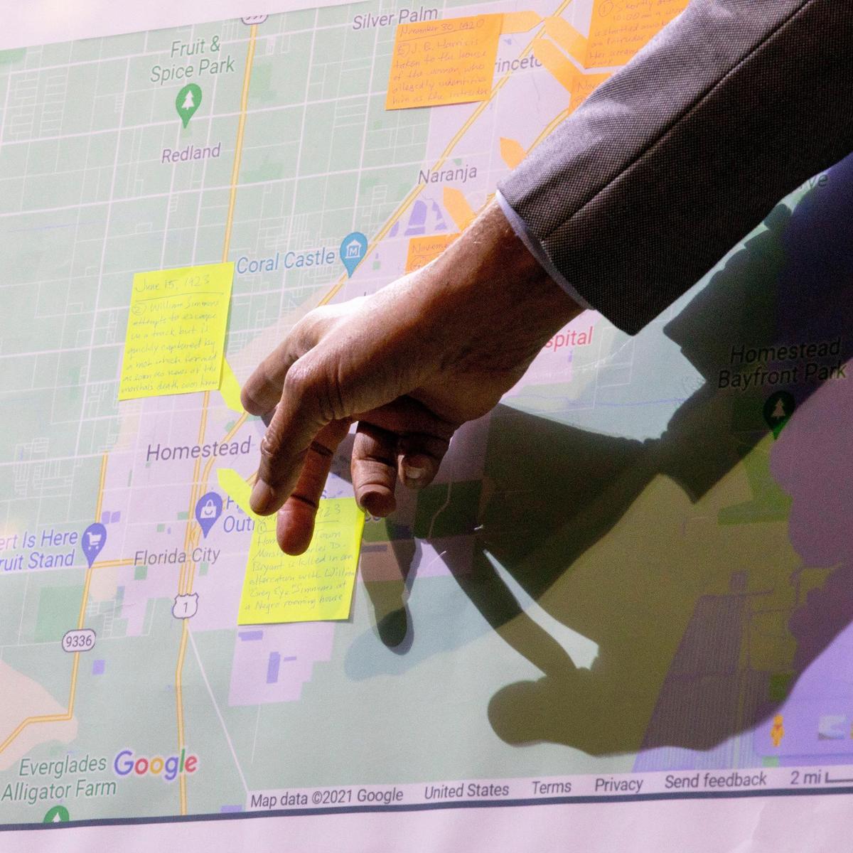 TEAR Steering Committee member Dinizulu Gene Tinnie points to areas on a map of South Miami-Dade County with markings signifying potential locations of where the lynchings of three victims J.B. Harris, William Simmons, and Roy Gaines, took place near Homestead, Florida, in the 1920s, during a Miami-Dade TEAR Initiative at Sweet Home Missionary Baptist Church in West Perrine, Florida, on Saturday, Nov. 13, 2021.