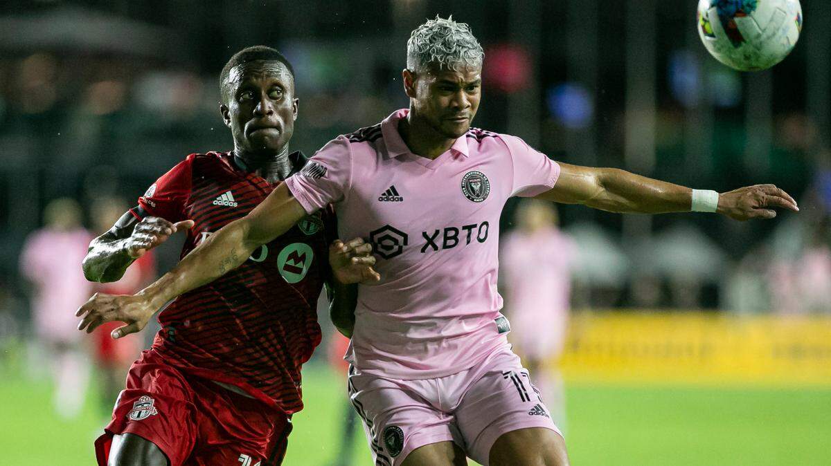 Inter Miami forward Ariel Lassiter (11) and Toronto FC midfielder Richie Laryea (19) fight for possession of the ball during the first half of an MLS soccer match at DRV PNK Stadium on Saturday, Aug. 20, 2022, in Fort Lauderdale, Fla.