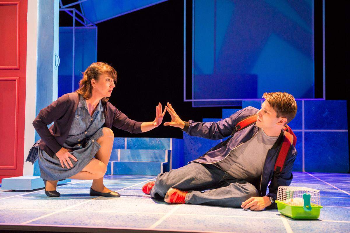Niki Fridh’s Judy carefully touches the fingertips of Ryan Didato as her son Christopher in Zoetic Stage’s ‘The Curious Incident of the Dog in the Night-Time.’