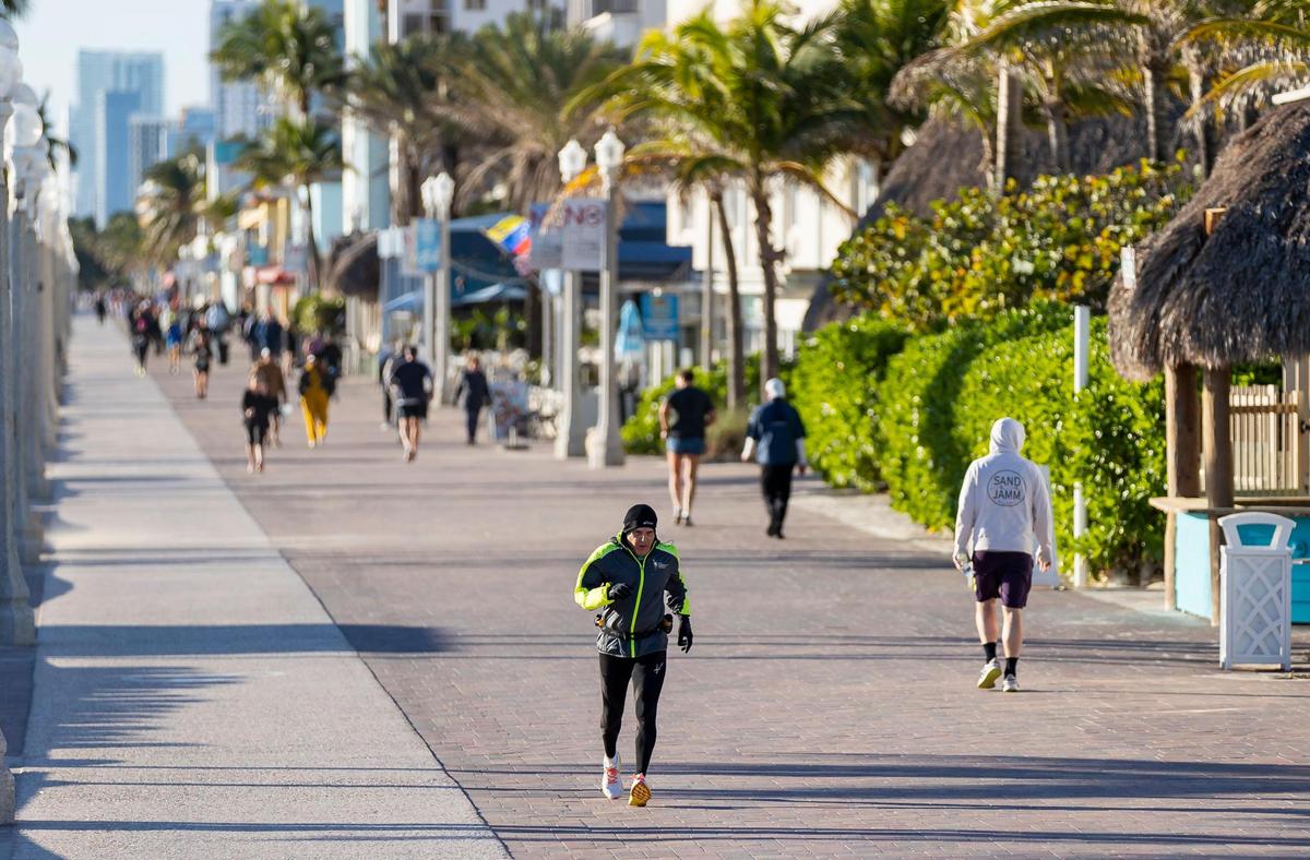 A runner makes his way down the Hollywood Beach Broadwalk as temperatures dip into the mid 40s on Saturday, Jan. 14, 2023, in Hollywood, Fla.
