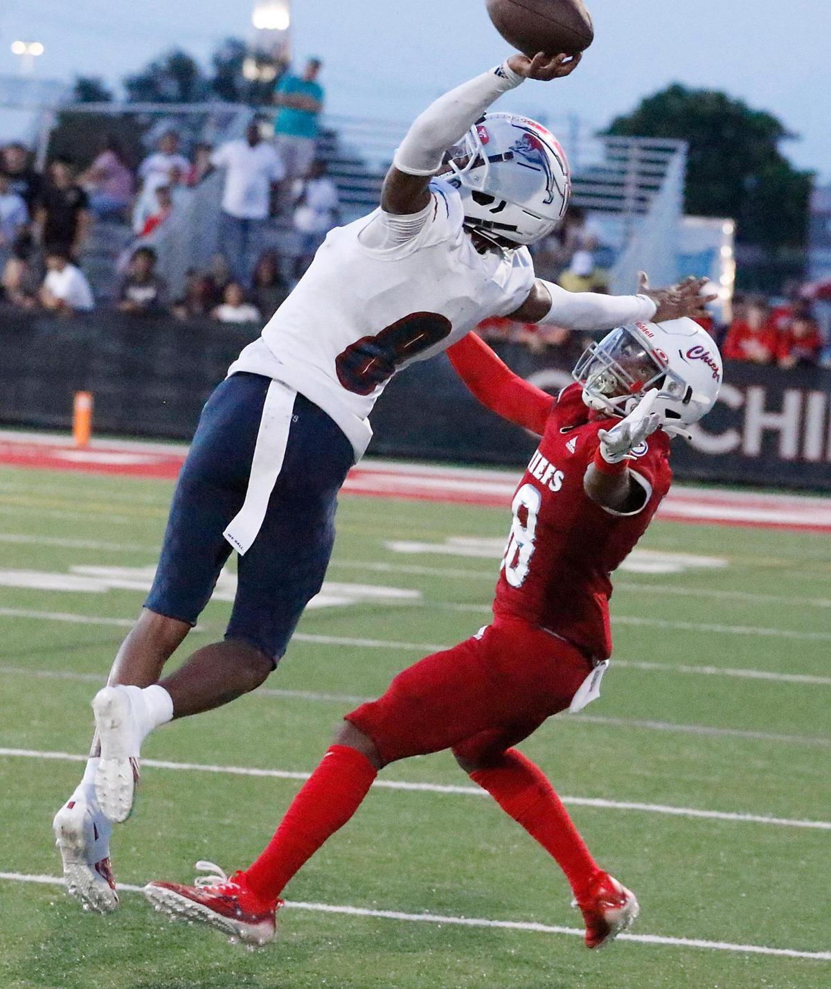Chaminade-Madonna Lions defensive back Chris Ewald (8) attempts to intercept a pass intended for Cardinal Gibbons Chiefs wide receiver Jalen Young during the football game on Friday, September 1, 2023 at Cardinal Gibbons HS in Fort Lauderdale. Andrew Uloza / for Miami Herald