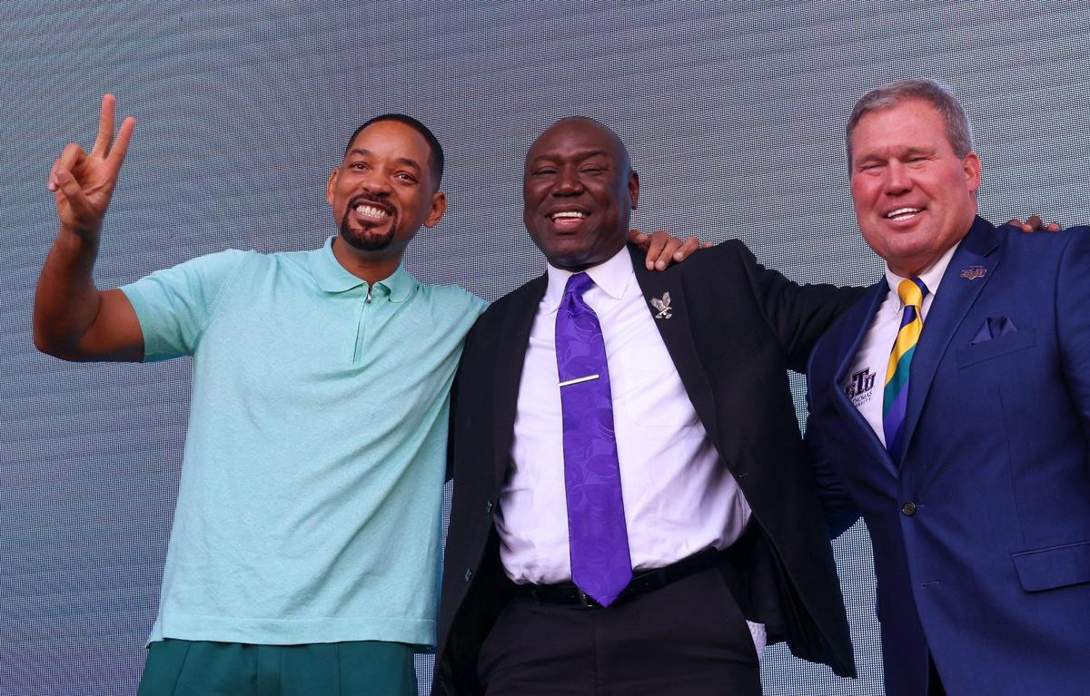 From left, Will Smith, Benjamin L. Crump, and St. Thomas University President David A. Armstrong share the stage during the naming ceremony, on Wednesday, Feb. 8, 2023. St. Thomas University named its law school the Benjamin L. Crump College of Law, the first law school in the country named for a practicing Black attorney, in Miami Gardens, Florida.