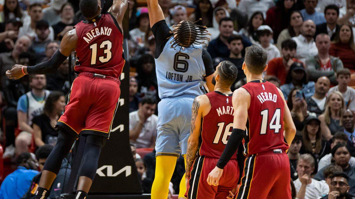 Miami Heat center Bam Adebayo (13) blocks Memphis Grizzlies forward Kenneth Lofton Jr. (6) during the fourth quarter of an NBA game at the Miami-Dade Arena on Wednesday, March 15, 2023, in downtown Miami, Fla.