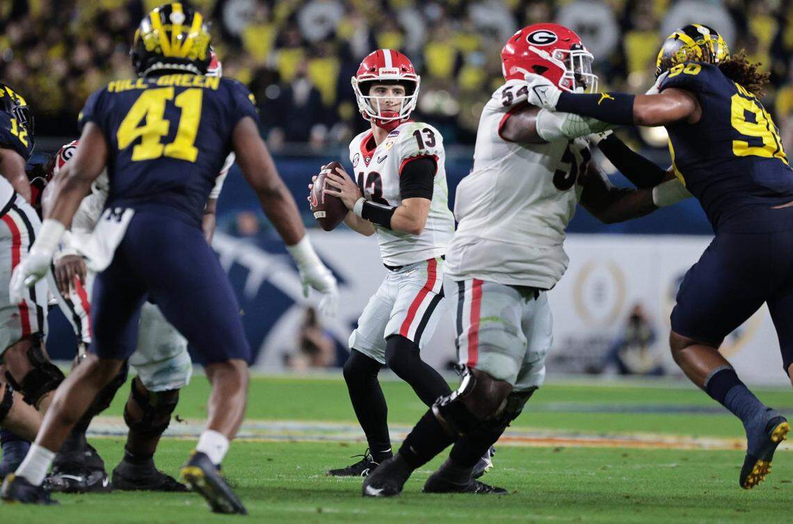 Georgia Bulldogs quarterback Stetson Bennett (13) sets up to pass in the second quarter against Michigan Wolverines during the 2021 College Football Playoff Semifinal at the Capital One Orange Bowl hosted at Hard Rock Stadium in Miami Gardens, Florida, on Friday, December 31, 2021.