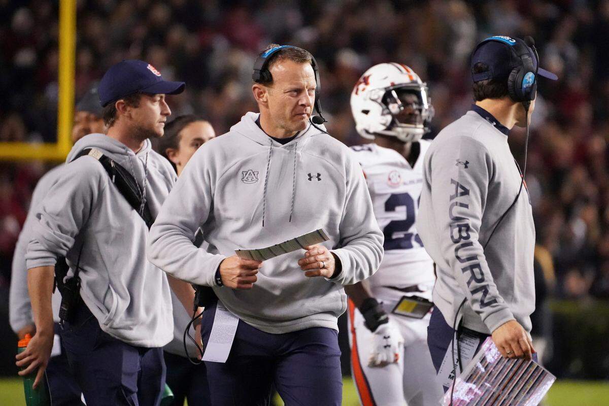 Auburn head coach Bryan Harsin walks near the sideline during a timeout in the first half of an NCAA college football game against South Carolina on Nov. 20, 2021, in Columbia, S.C. Harsin says he is “not planning on going anywhere” as he tries to navigate a tumultuous offseason of turnover in his program. Auburn went 6-7 in its first season under Harsin, who was hired away from Boise State a little more than 13 months ago.