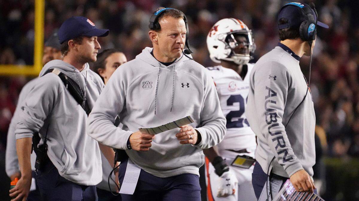 Auburn head coach Bryan Harsin walks near the sideline during a timeout in the first half of an NCAA college football game against South Carolina on Nov. 20, 2021, in Columbia, S.C. Harsin says he is “not planning on going anywhere” as he tries to navigate a tumultuous offseason of turnover in his program. Auburn went 6-7 in its first season under Harsin, who was hired away from Boise State a little more than 13 months ago.
