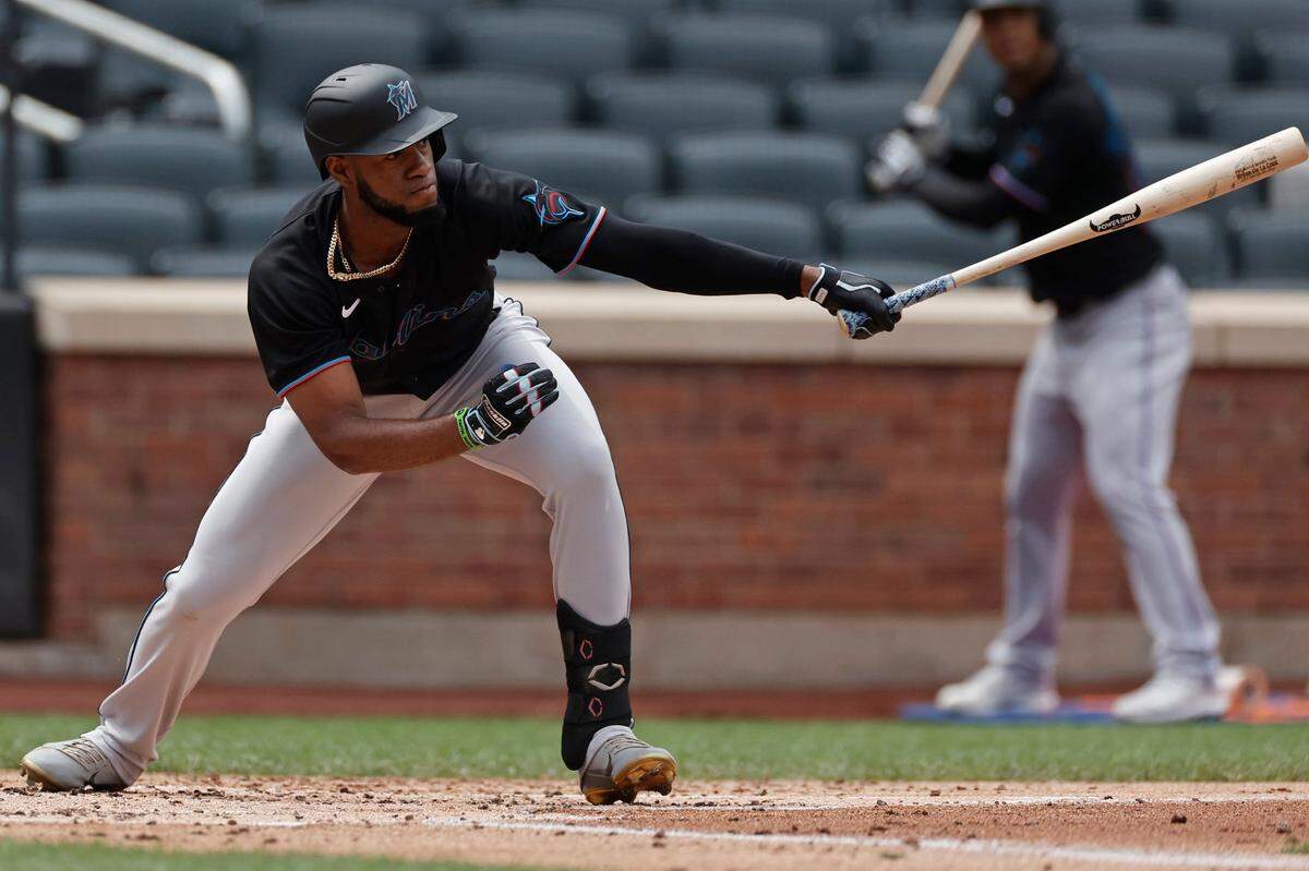 Miami Marlins’ Bryan De La Cruz hits an RBI single against the New York Mets during the second inning of the first game of a baseball doubleheader that started April 11 and was suspended because of rain, Tuesday, Aug. 31, 2021, in New York.